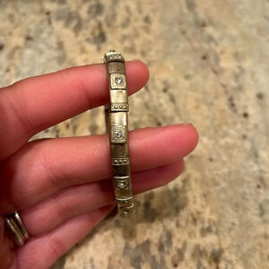 Woman's gold stretchy bracelet with cute little fake diamonds in it